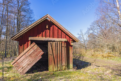 Old red shed with hanging doors