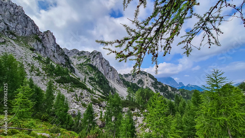 Scenic hiking trail to mountain peak Cima del Cacciatore in remote Julian Alps, Friuli-Venezia Giulia, Italy. Trailhead from Monte Santo di Lussari, Camporosso. Wanderlust in untamed Italian Alps