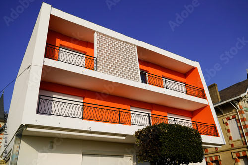 retro orange white contemporary residential new building with terrace balcony from fifties design in france photo
