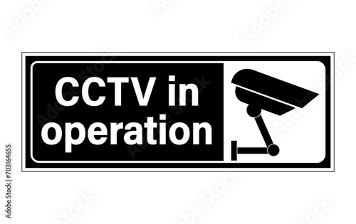 CCTV in operation, information   sign with text on the left and silhouette of security camera on the right. Sticker, horizontal strip, black background.