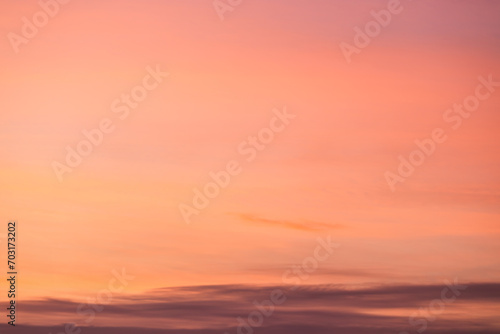 A beautiful sky tinted by the sun leaving vibrant shades of gold, pink, blue and multicolored. Clouds in the twilight evening and morning sky. Cloudy sky background in the evening and during the day.