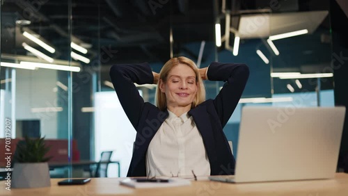 Happy satisfied caucasian business woman relax sit at office desk finished laptop pc work put hands behind head feel satisfied with work well done stress relief peace of mind concept chill at work. photo