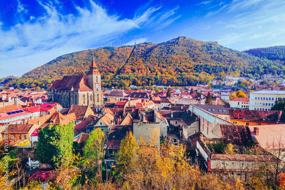 Brasov, Romania. Autumn sunny colors on medieval Transylvania and Carpathian Mountains range.