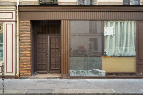 Photography old parisian storefront facade painted in brown , commercial boutique vitrine te