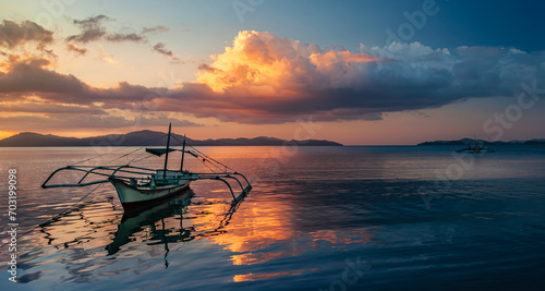 Serene Seascape with Islands and Bangkas after Sunset photo