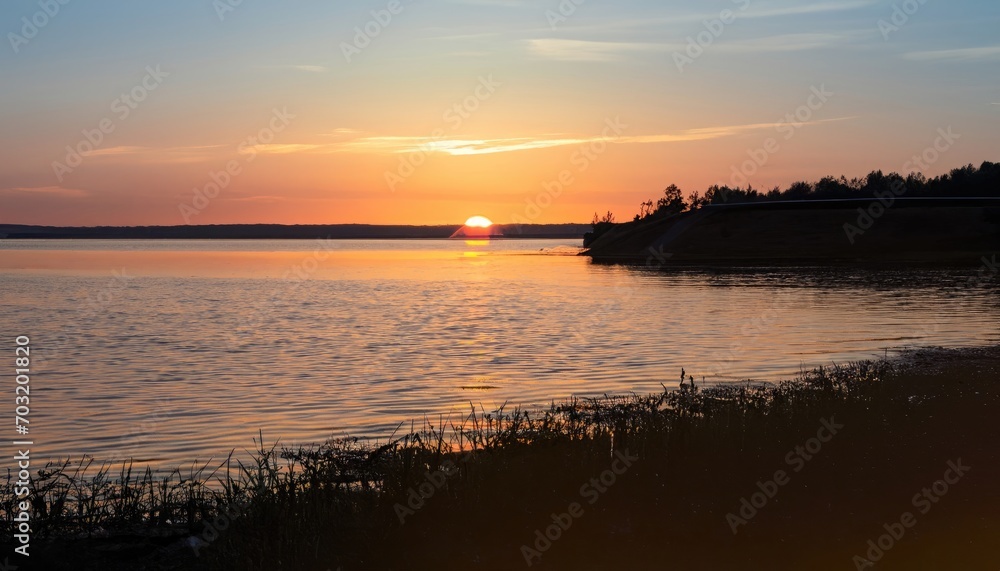 Sunset at the coast of the lake. Nature landscape