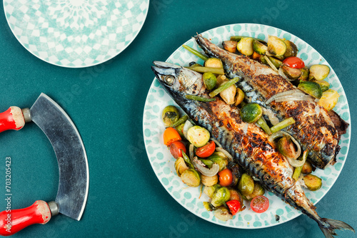 Grilled mackerel fish with vegetables. photo