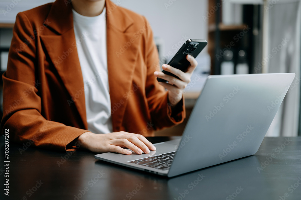 business documents on office table with smart phone and digital tablet and graph financial and woman working . business documents on office table with smart phone and digital tablet and graph financial and woman working .