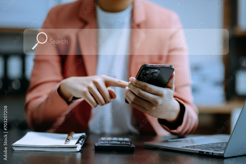 Fototapeta premium Searching Browsing Internet Data Information Networking Concept with blank search bar. woman working with mobile phone and laptop computer