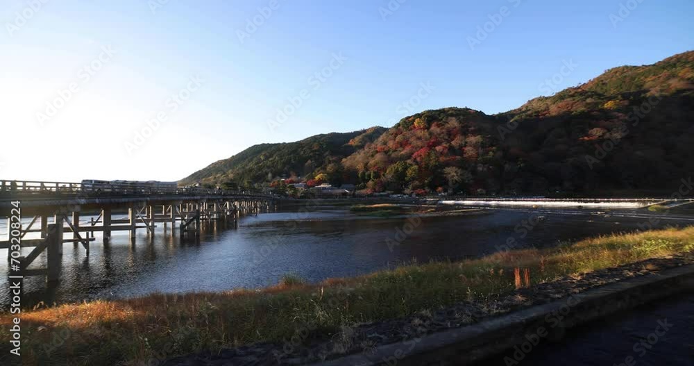 A dawn of Togetsukyo bridge near Katsuragawa river in Kyoto in autumn wide shot A dawn of Togetsukyo bridge near Katsuragawa river in Kyoto in autumn wide shot