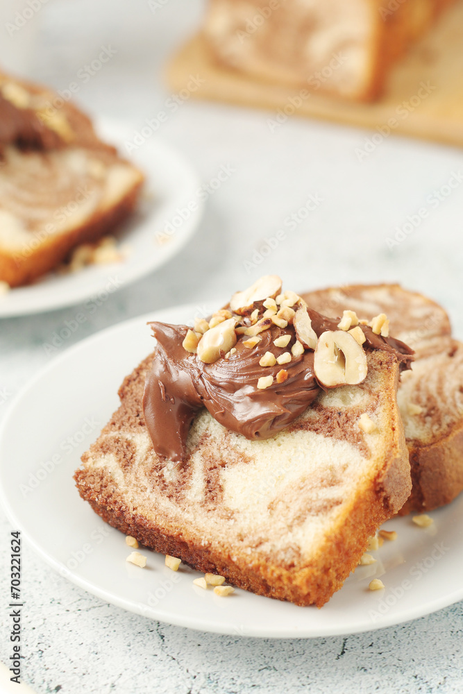 A piece of marble biscuit with chocolate cream and nuts A piece of marble biscuit with chocolate cream and nuts