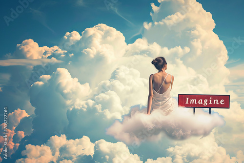 Young dreamy woman sitting on clouds thinking and looking at the sky like in a dream with a board sign with written imagine word © Keitma