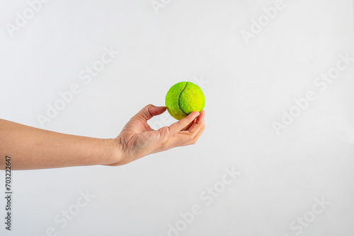 Tennis ball in hand on white background (with clipping path) © apinya
