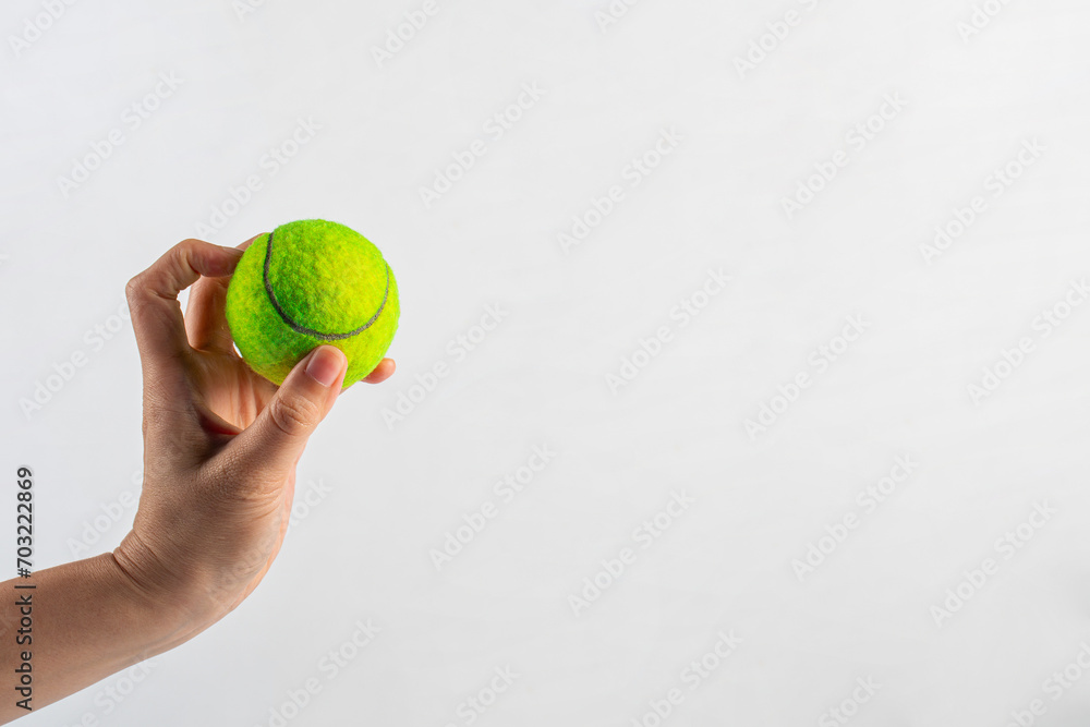 Tennis ball in hand on white background (with clipping path)