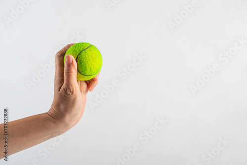 Tennis ball in hand on white background (with clipping path) © apinya