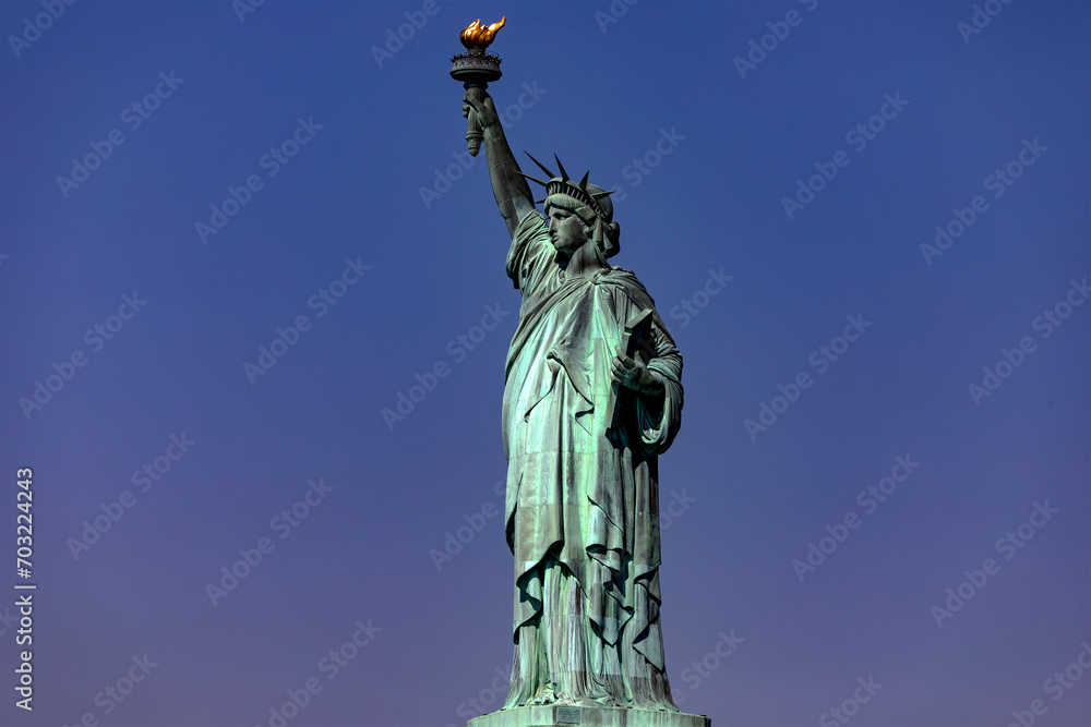 Fototapeta premium The famous Statue of Liberty, icon of New York and the Big Apple, symbol of the city of Manhattan and of freedom and democracy in the world.