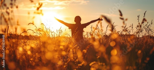 Child playing in golden wheat field at sunset. Childhood and freedom.