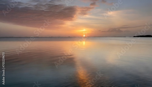 the beauty of a sunset over the sea. Envision the sun dipping below the horizon, painting the sky in hues of gold and pink, reflecting on the calm waters. This visual should evoke a sense of peace and