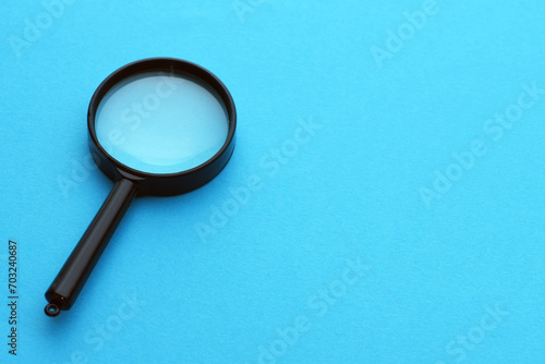 magnifying glass magnifier loupe search symbol on blue background with copy space