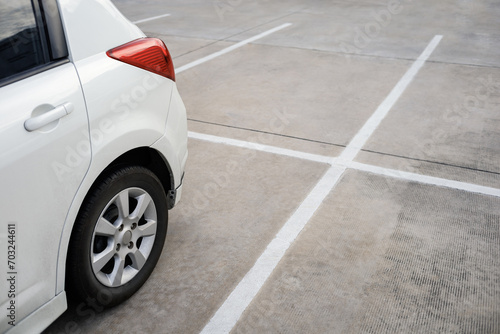 close up of modern car in parking lot, grunge surface of street, car parked in the right position in outdoor shopping plaza carpark area, shallow depth of field photo