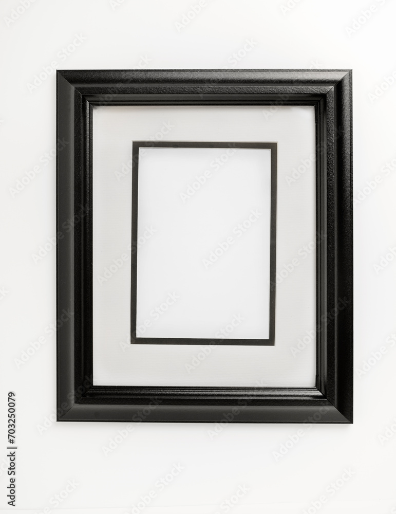 Vertical black and white picture frame mounted on the wall Vertical black and white picture frame mounted on the wall