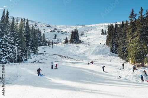 People with sleds on a slope in the winter mountain .Vitosha Mountain ,Aleko Hut