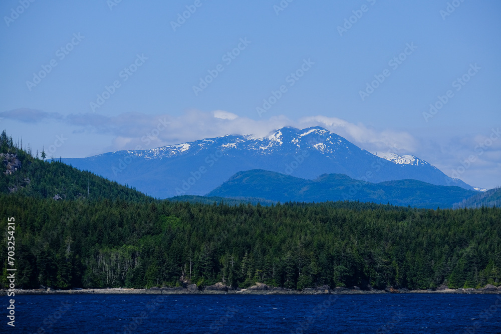 Panoramic morning or day time landscape nature coastal scenery with beautiful blue sky and dramatic cloudscapes in Alaska Inside Passage glacier mountain range view