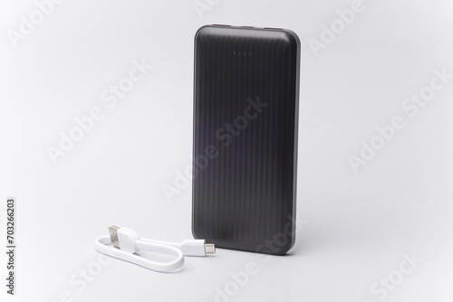 Black power bank with cable on a white background