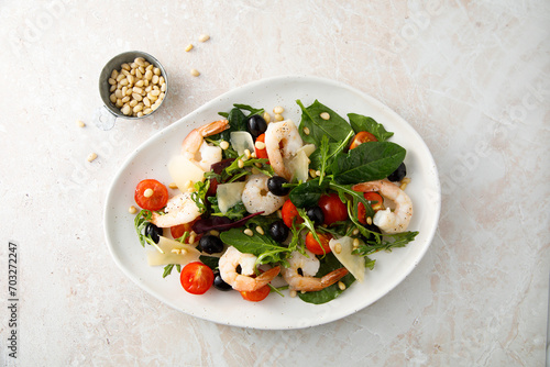 Shrimp salad with pine nuts and cheese