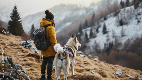 Close-up young trekking with Siberian husky dog on the mountain photo