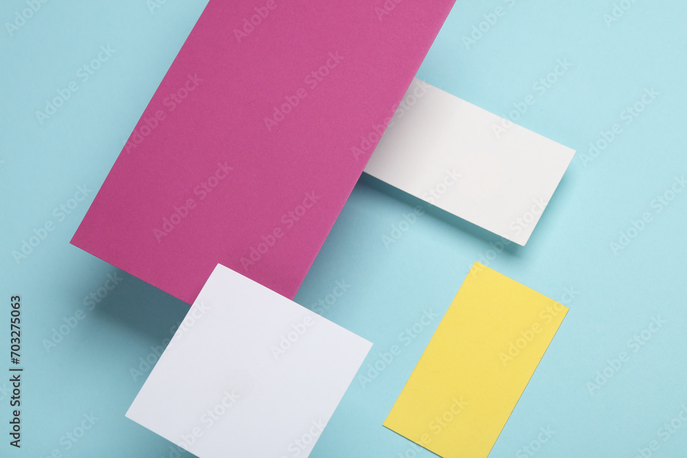 Group of floating colored blank cards sheet with shadow on blue background. Minimalism business brand template, creative layout Group of floating colored blank cards sheet with shadow on blue background. Minimalism business brand template, creative layout