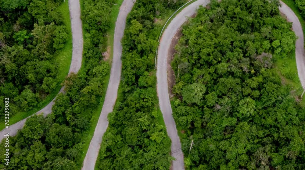aerial video of dense forests in mountainous areas with views of winding roads crossing the mountains aerial video of dense forests in mountainous areas with views of winding roads crossing the mountains