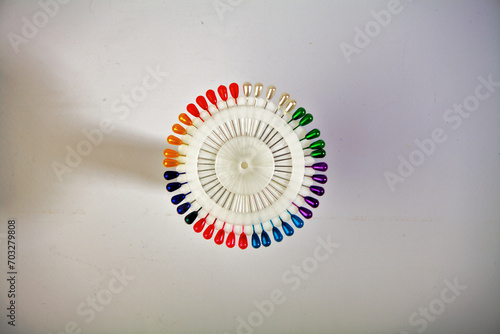 Sewing needles. A spool of colored sewing threads for tailors. On a white isolated background. used by factories in the garment industry.