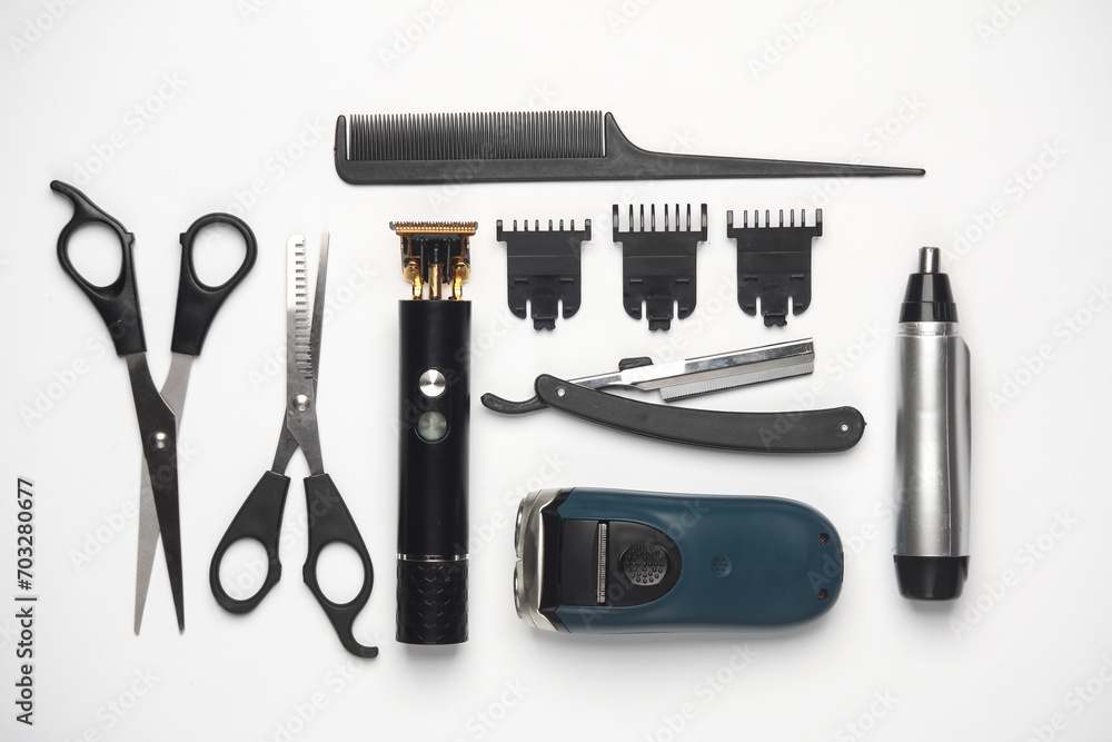 Trimmers, hair cutting scissors and razors, comb on a white background. Barber's working tools. Creative layout. Flat lay Trimmers, hair cutting scissors and razors, comb on a white background. Barber's working tools. Creative layout. Flat lay