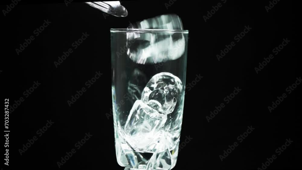 Dropping Ice Cube into Water Glass in Slow Motion stock video footage Dropping Ice Cube into Water Glass in Slow Motion stock video footage