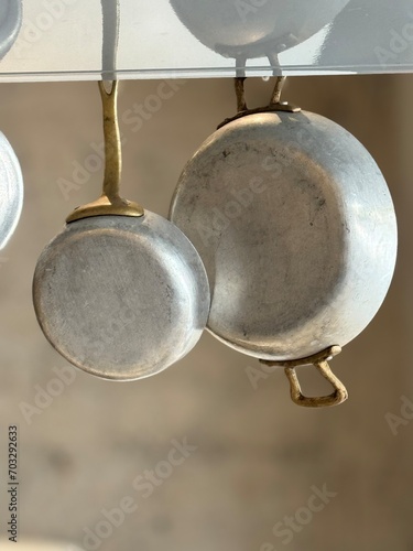Many pans hanging in a restaurant kitchen