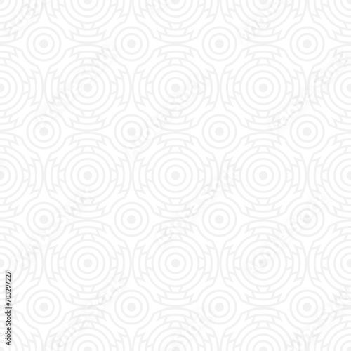 Seamless trendy pattern of circles and arcs, geometric white shapes for textiles and wallpaper. Festive Christmas pattern on a gray background.