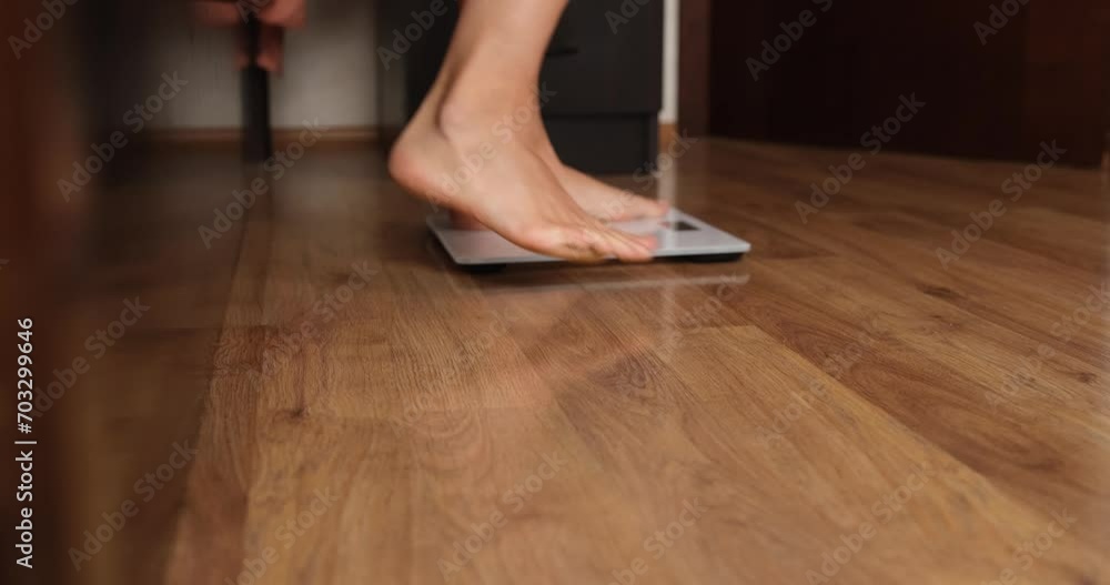 Women legs get out of bed and measure body weight on scales. Weight control and diet concept Women legs get out of bed and measure body weight on scales. Weight control and diet concept