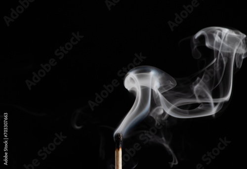Smoke from a match that was just put out, isolated on black background
