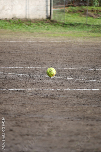 soccer ball stationary on a muddy soccer field