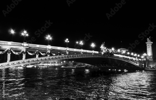 A black and white photo of the river Seine and a bridge, in Paris, France © Wirestock