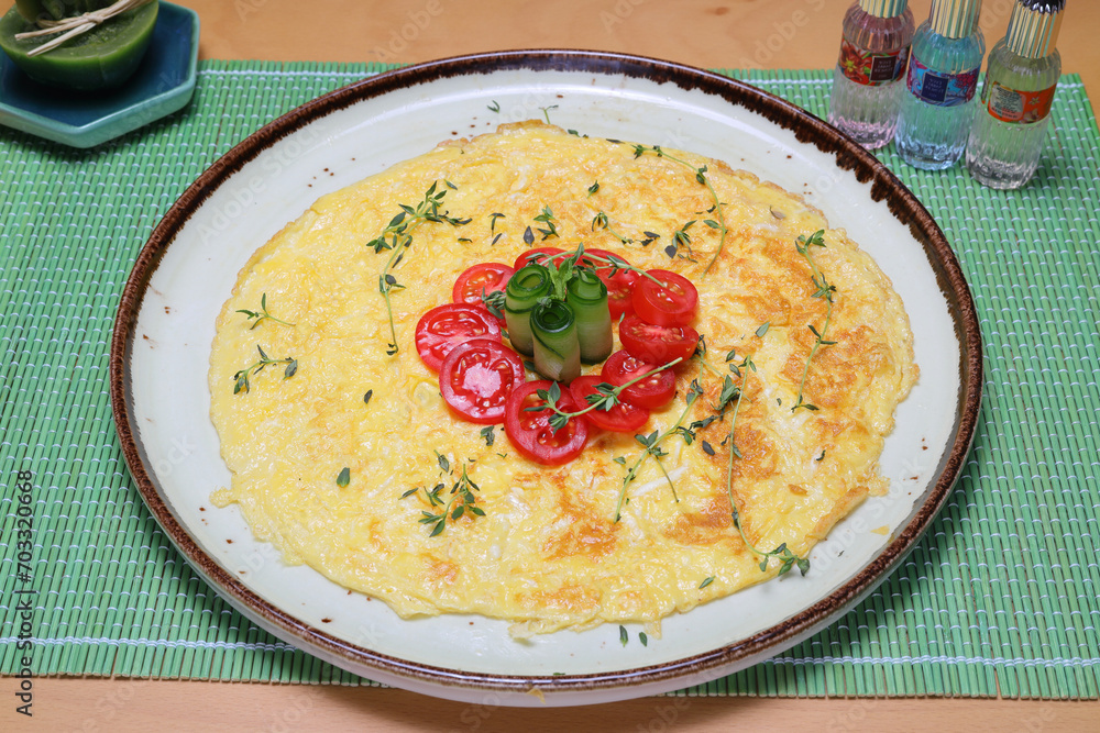 Homemade omelette with vegetables on white plate on wooden background. Homemade omelette with vegetables on white plate on wooden background.