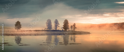 Sunrise on a moody and foggy morning at Lake Yellowstone in the Yellowstone National Park, Wyoming photo