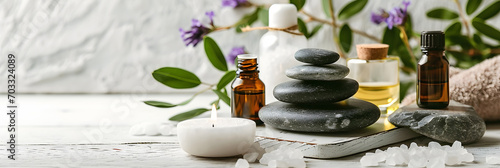 beauty treatment items for spa procedures on white wooden table. massage stones, essential oils and sea salt. copy space