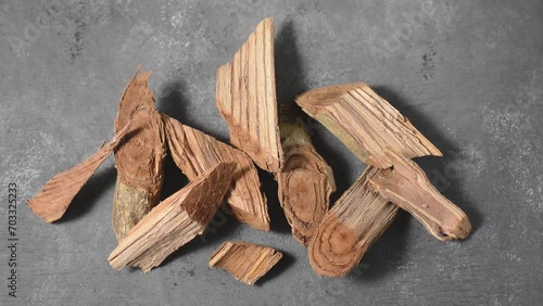 pieces of kothala himbutu bark wood, herb used widely in the ayurvedic medicine to treat diabetes and obesity, dried woody traditional medicine native to sri lanka on black textured surface photo