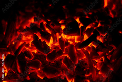 Smoldering fire with coals. Coals burn in the night © alones
