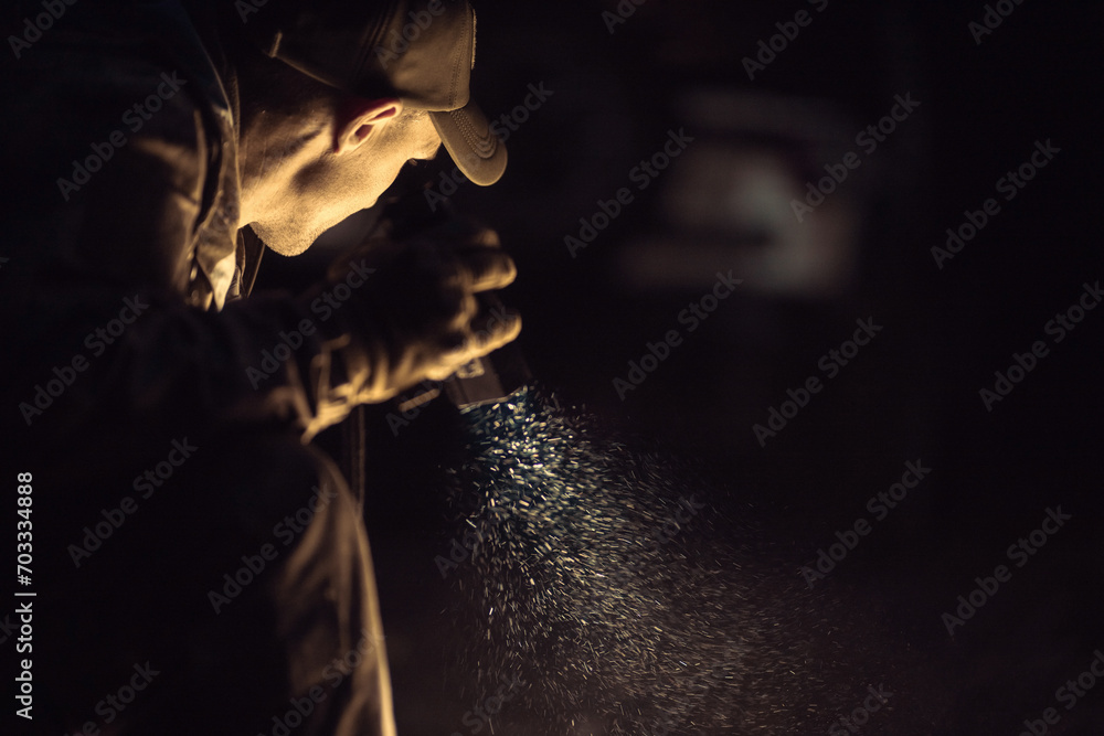 A Man with a Flashlight in His Hand During Night Time