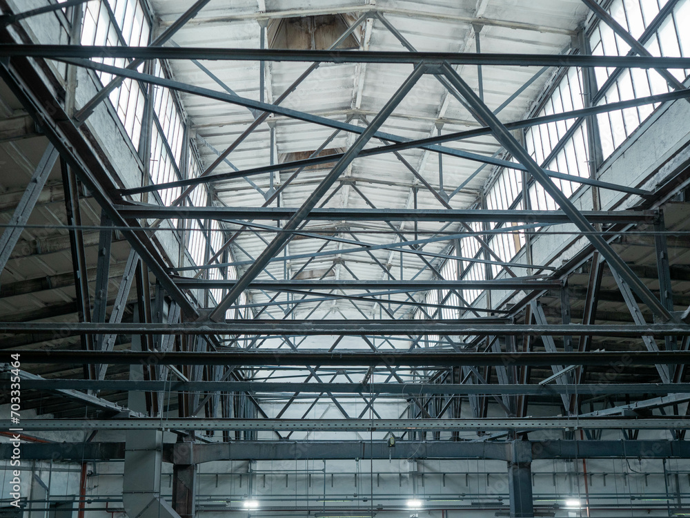Interior of large industrial hall with metal roof trusses Interior of large industrial hall with metal roof trusses