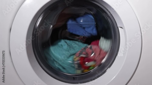 laundry, washing machine washes and rinses clothes in the bathroom