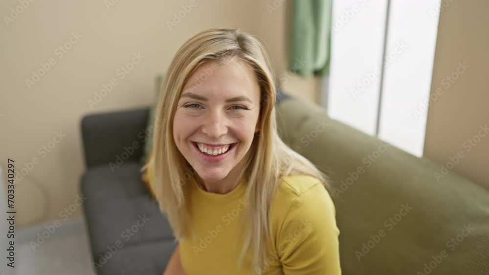 Young blonde woman wearing t shirt sticking tongue out happy with funny expression. emotion concept. at home Young blonde woman wearing t shirt sticking tongue out happy with funny expression. emotion concept. at home